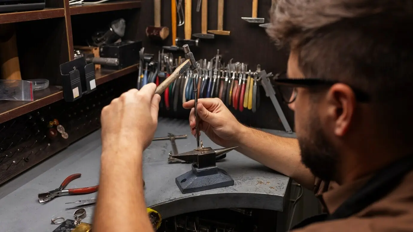 Profile view of a jeweler crafting jewellery