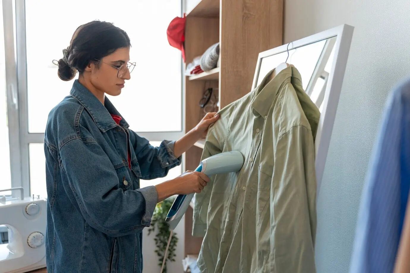 Medium shot of a woman repairing clothes.